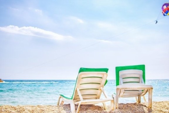 a chair sitting in front of a beach